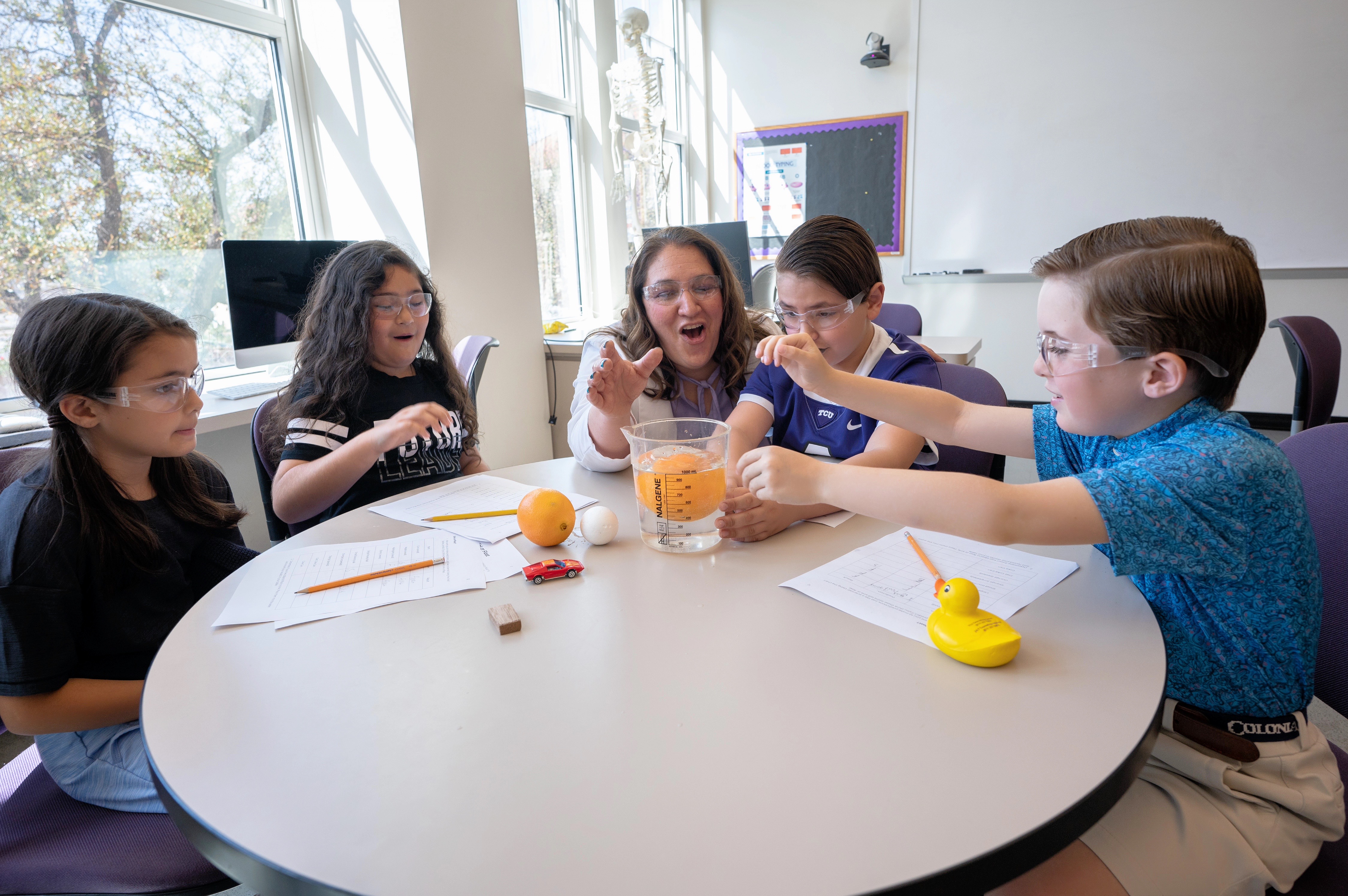 group of young students with experiment