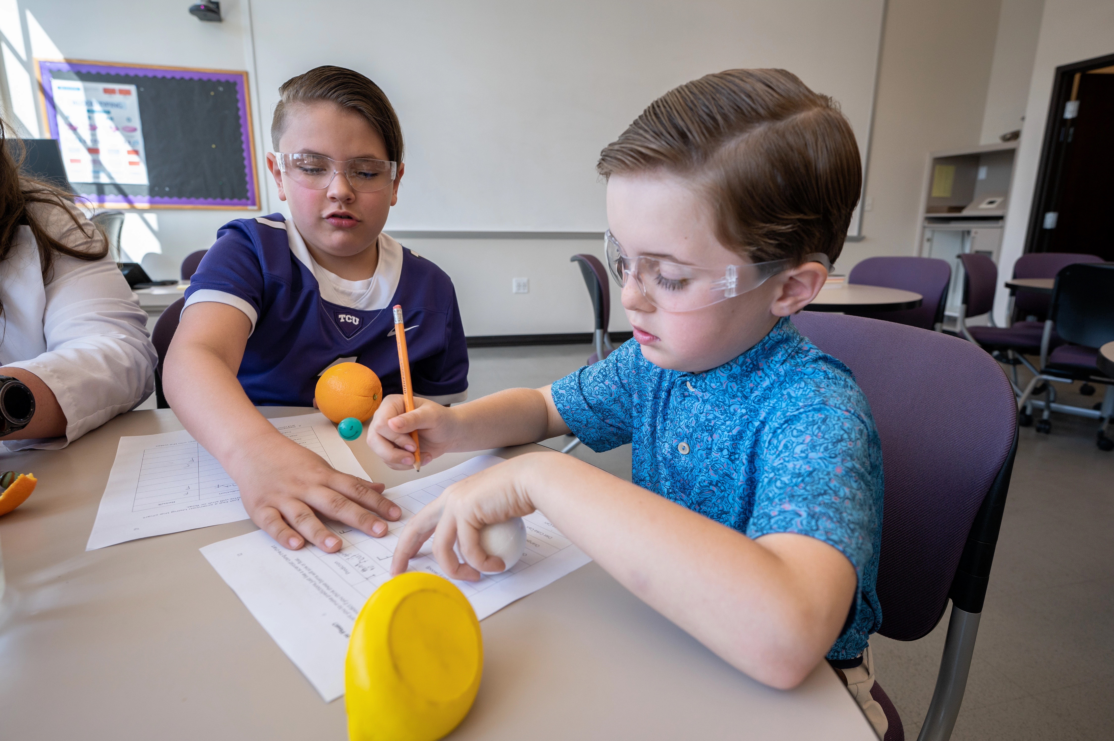 two young boys conducting science experiment