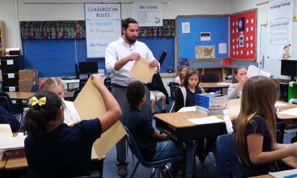 Latino male teacher in classroom