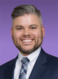 Rocco Williams in front of a purple background