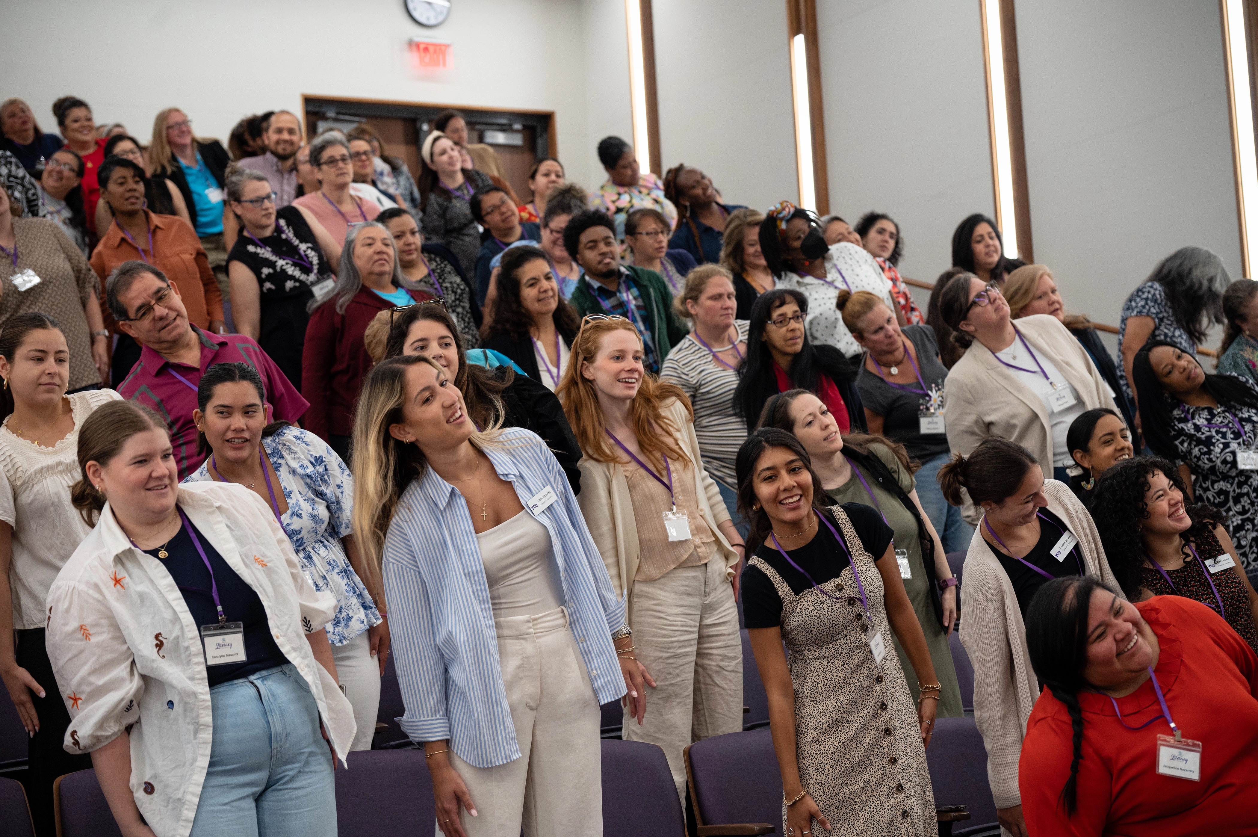 conference attendees standing, leaning and smiling