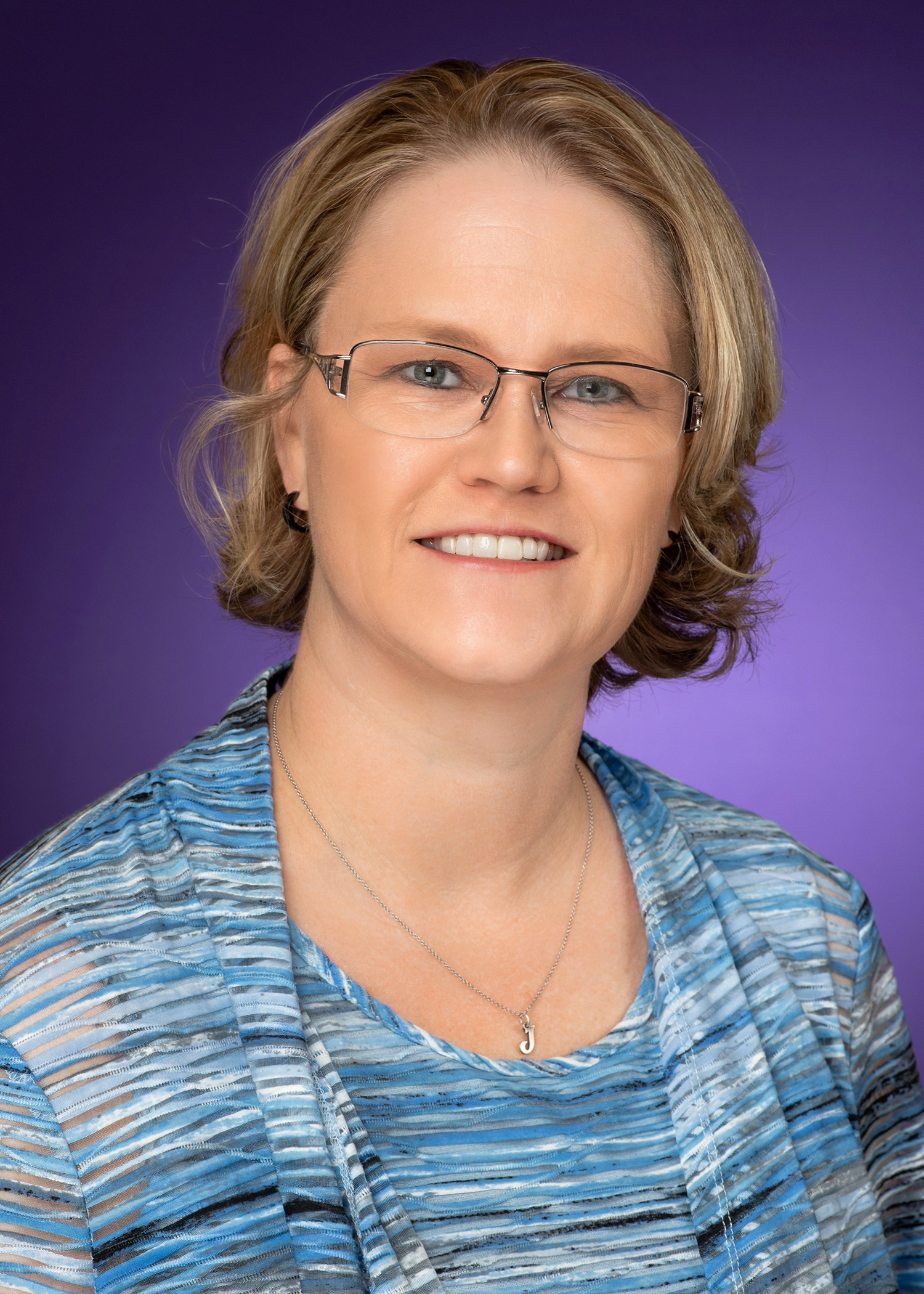 A headshot of Jo Beth Jimerson against a purple backdrop.