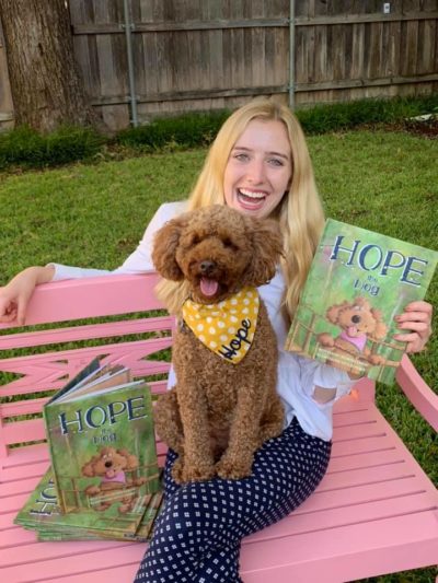 Allison Davis and her dog, Hope, with her book
