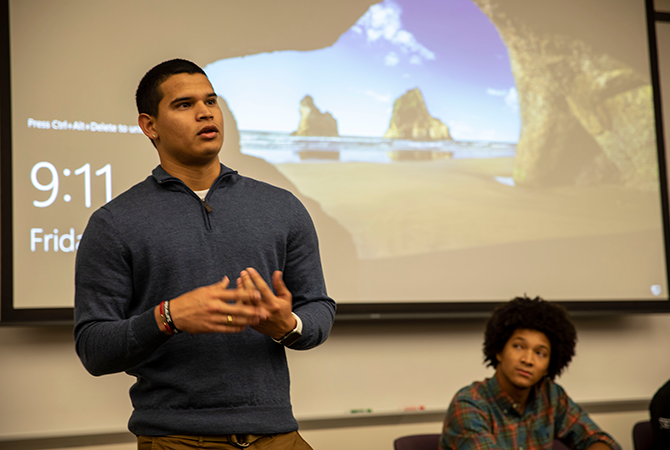 Latino male student presenting