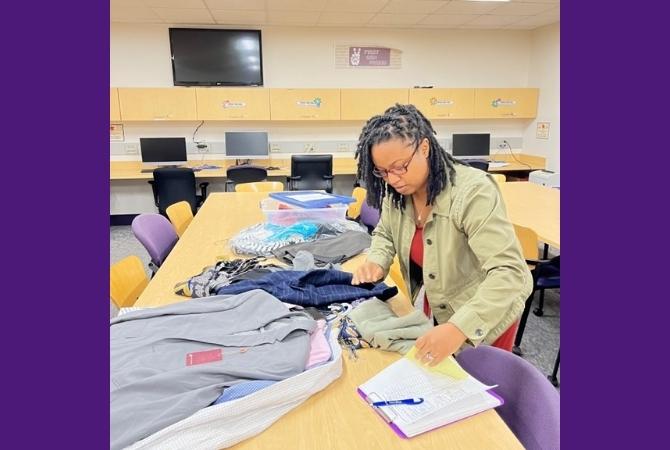 Jowelle Mitchell sorts clothes for the pop-up shop
