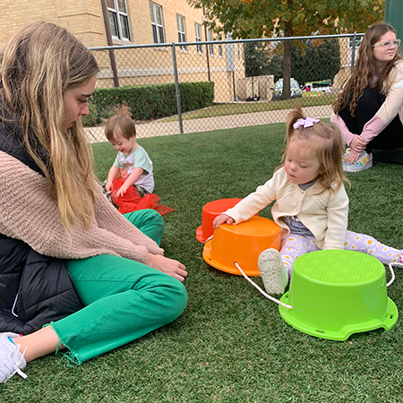 TCU student testing Recess Kit with KinderFrogs student