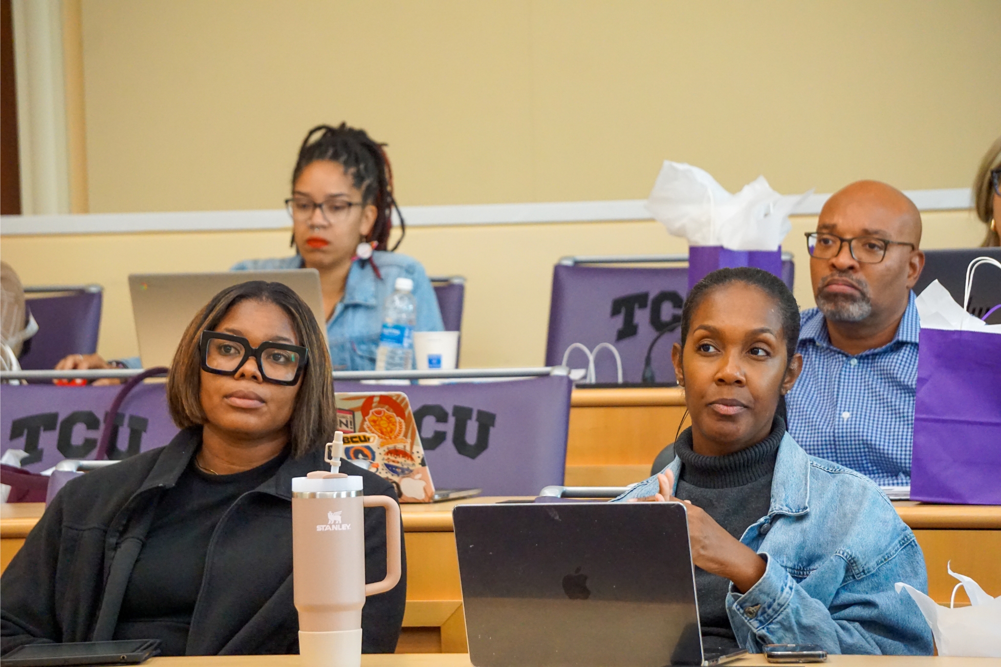 holmes scholars tentatively listening to speaker