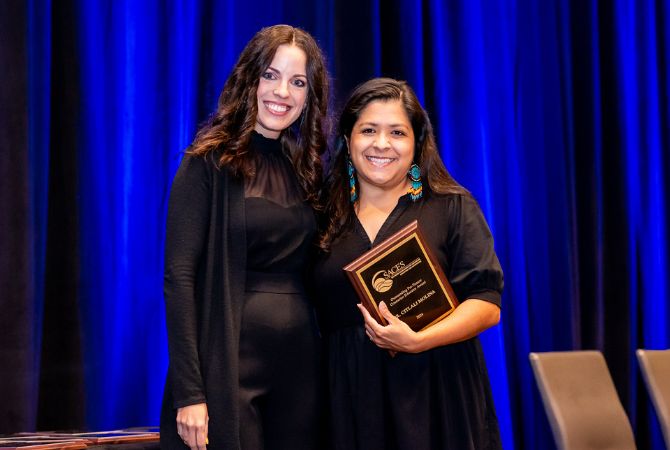 professor molina with award smiling