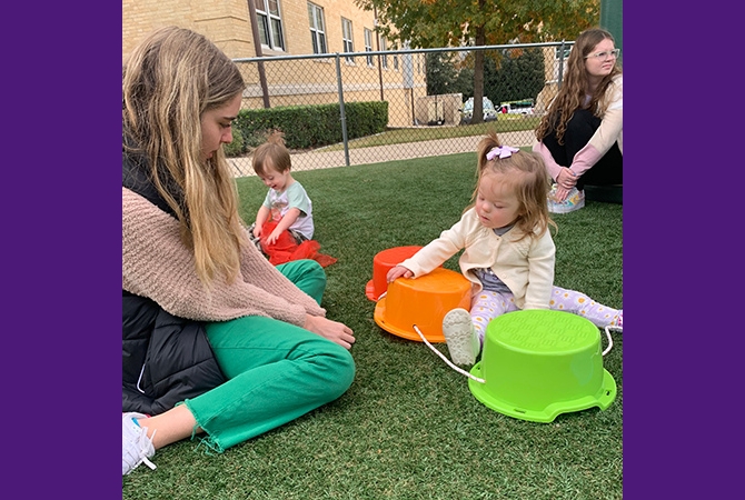 TCU student testing recess kit with KinderFrogs student