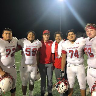 Coach MacDougall with a group of his football players