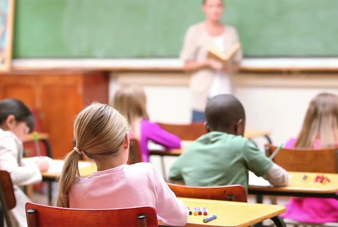 Young students sitting at their desks in a classroom