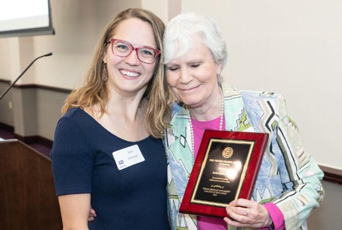 women smiling with award